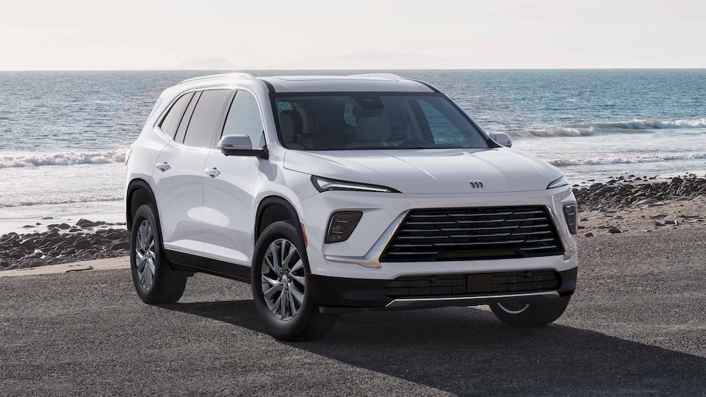 A white 2026 Buick Enclave SUV parked on the beach