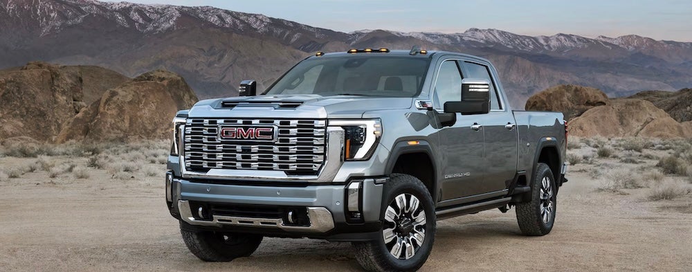 A gray 2026 GMC Sierra 2500 HD pickup truck parked in a desert valley