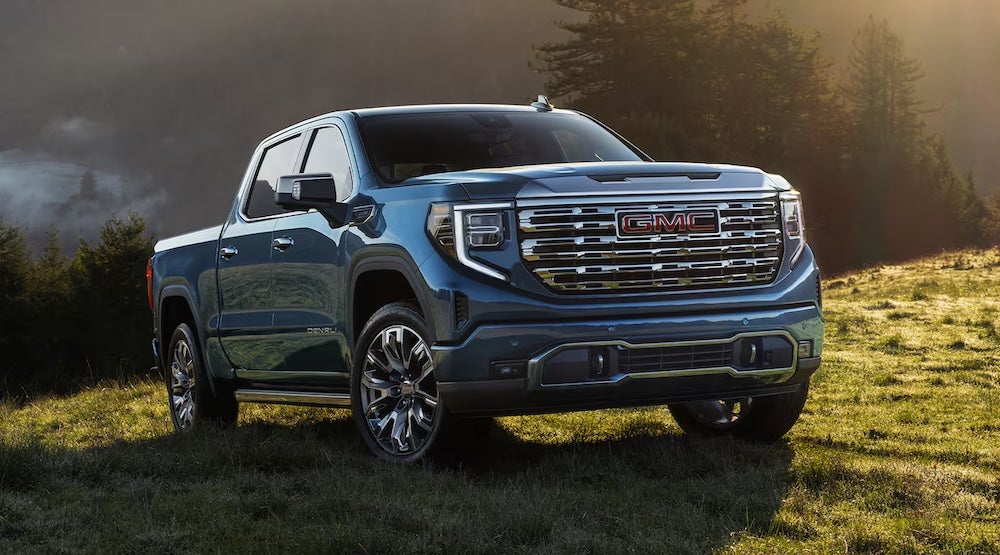 A gray 2026 GMC Sierra 1500 truck on a grassy hill